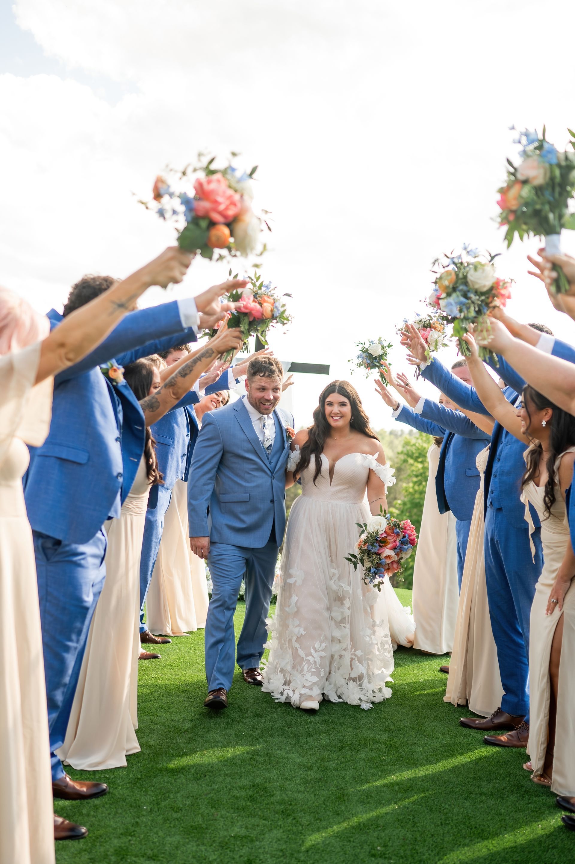 Bridal party cheering for newlyweds during outdoor wedding celebration in the Blue Ridge Mountains