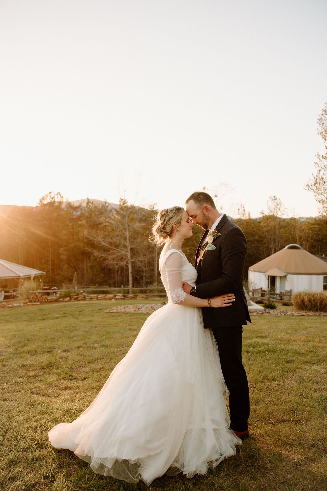 Bride and groom with foreheads touching at golden hour in the Blue Ridge Mountains.