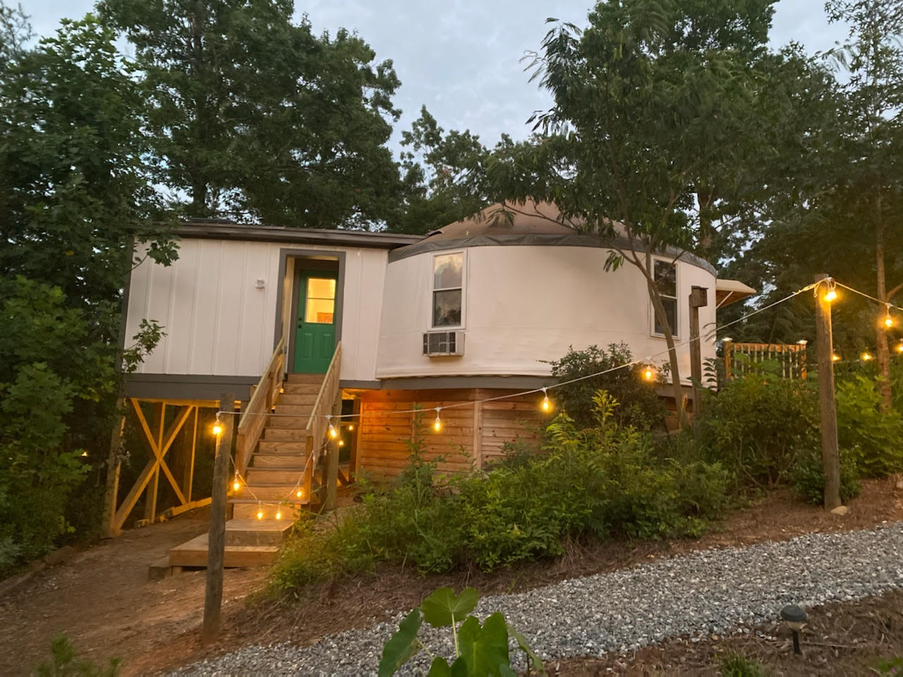 Glamping yurt lit up at night at Serenity Ridge
