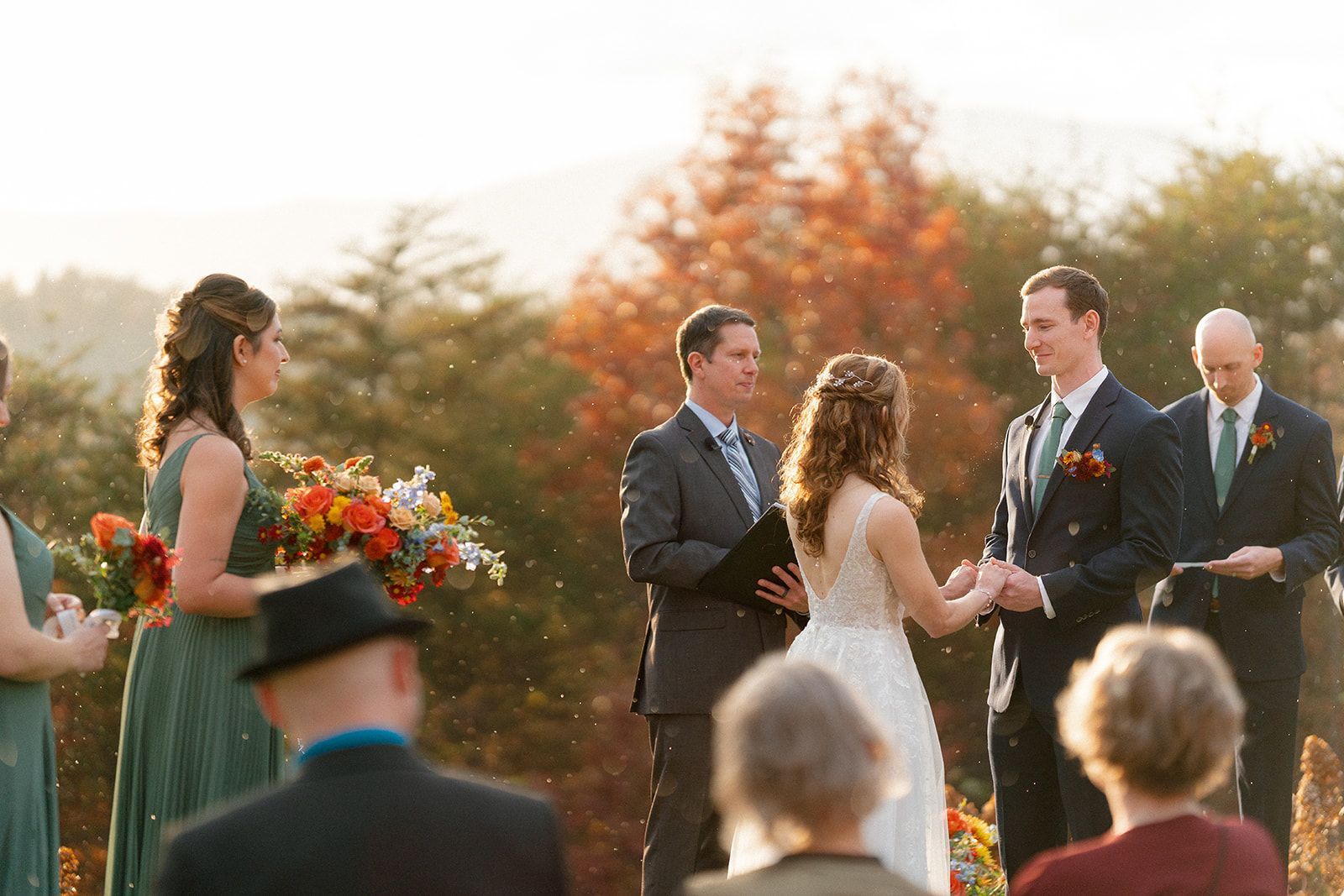 Bride and groom exchanging vows during outdoor ceremony in the fall in North Carolina