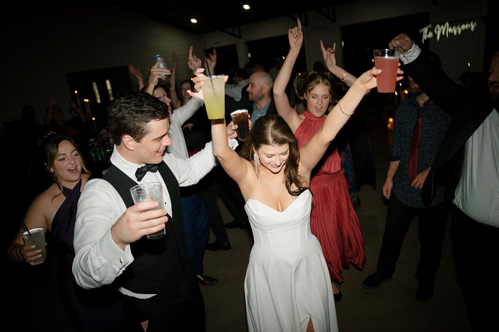 Guests celebrating on packed dance floor during lively wedding reception at mountain venue