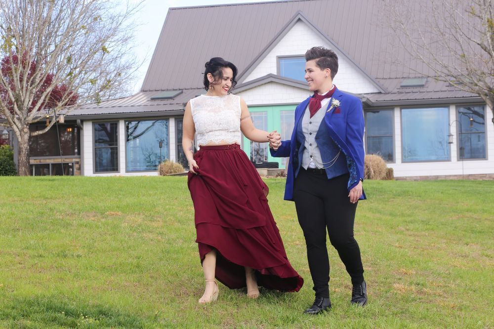 LGBTQ-friendly wedding venue: couple walking hand in hand at Hilltop House at Serenity Ridge.