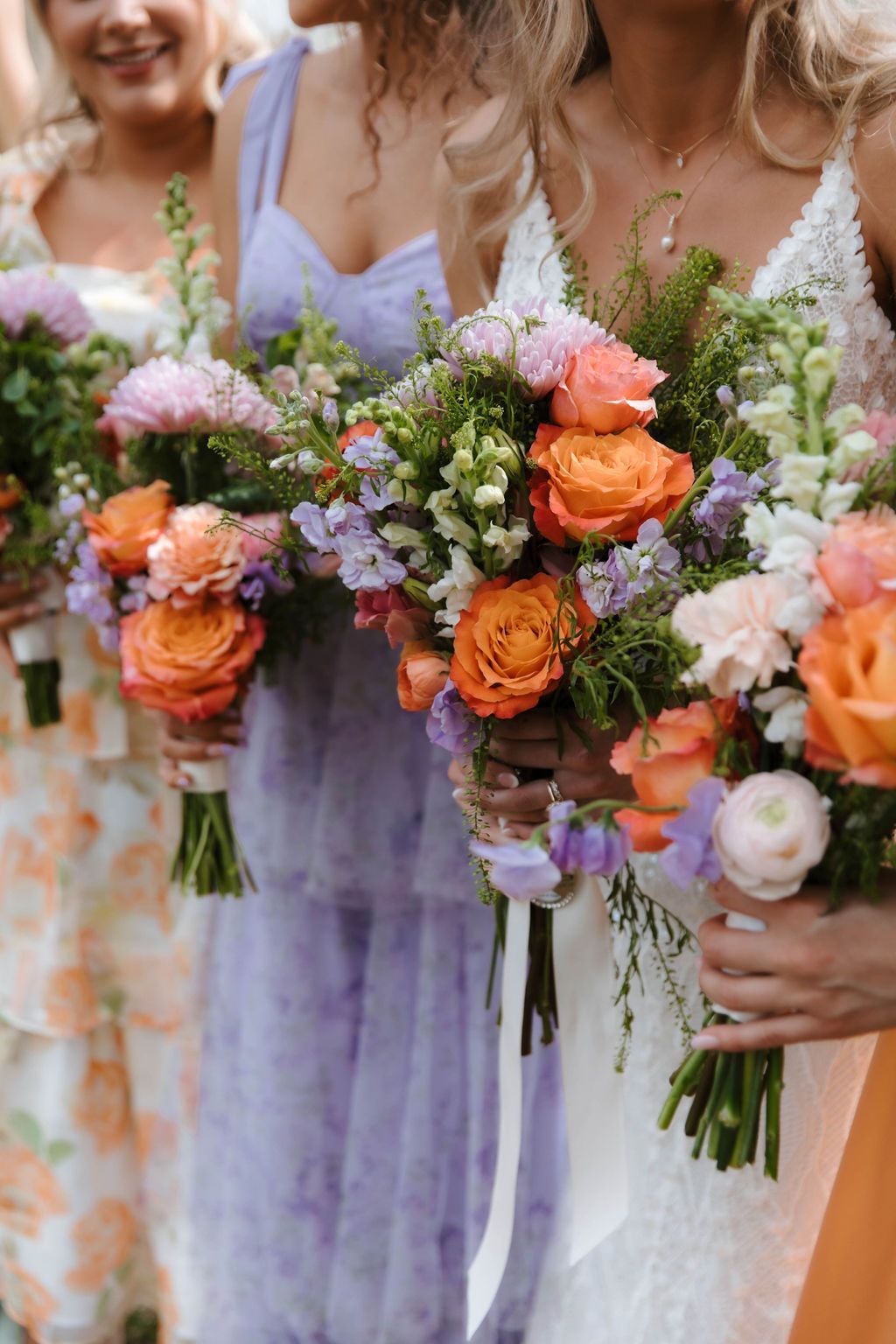Colorful wedding bouquets and bridesmaid dress details during Blue Ridge mountain wedding celebration