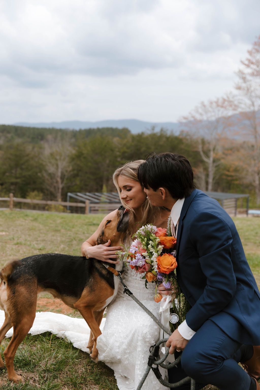 Bride and groom with their dog during outdoor wedding portraits overlooking North Carolina mountain views