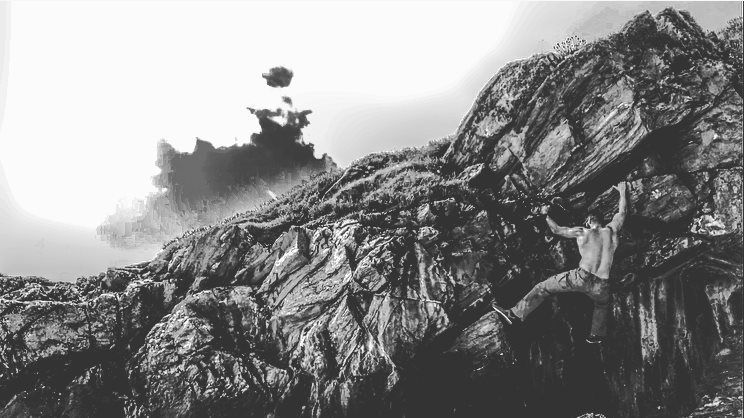 A black and white photo of a large rock formation with a boat in the background