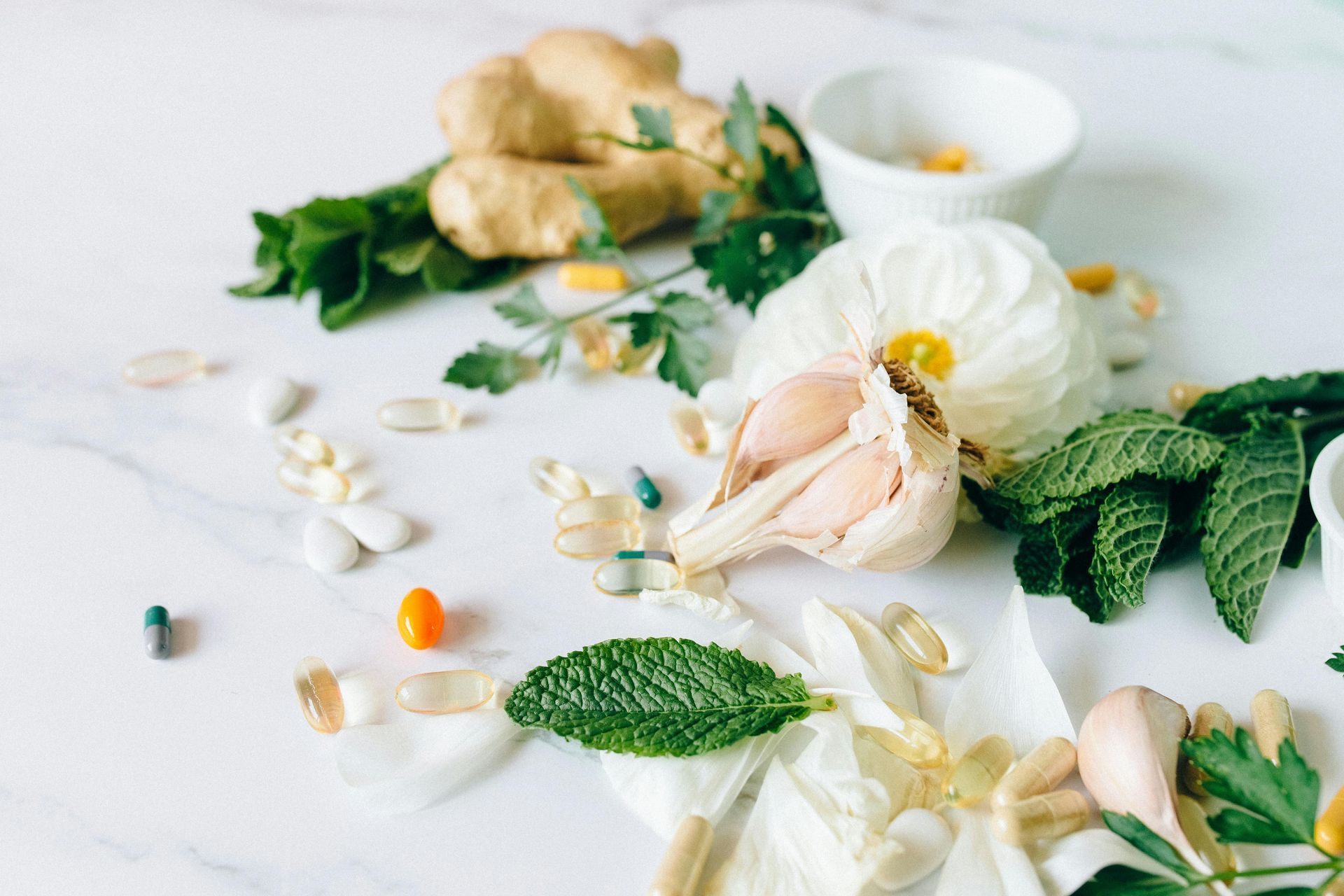 There are many different types of herbs and pills on the table.