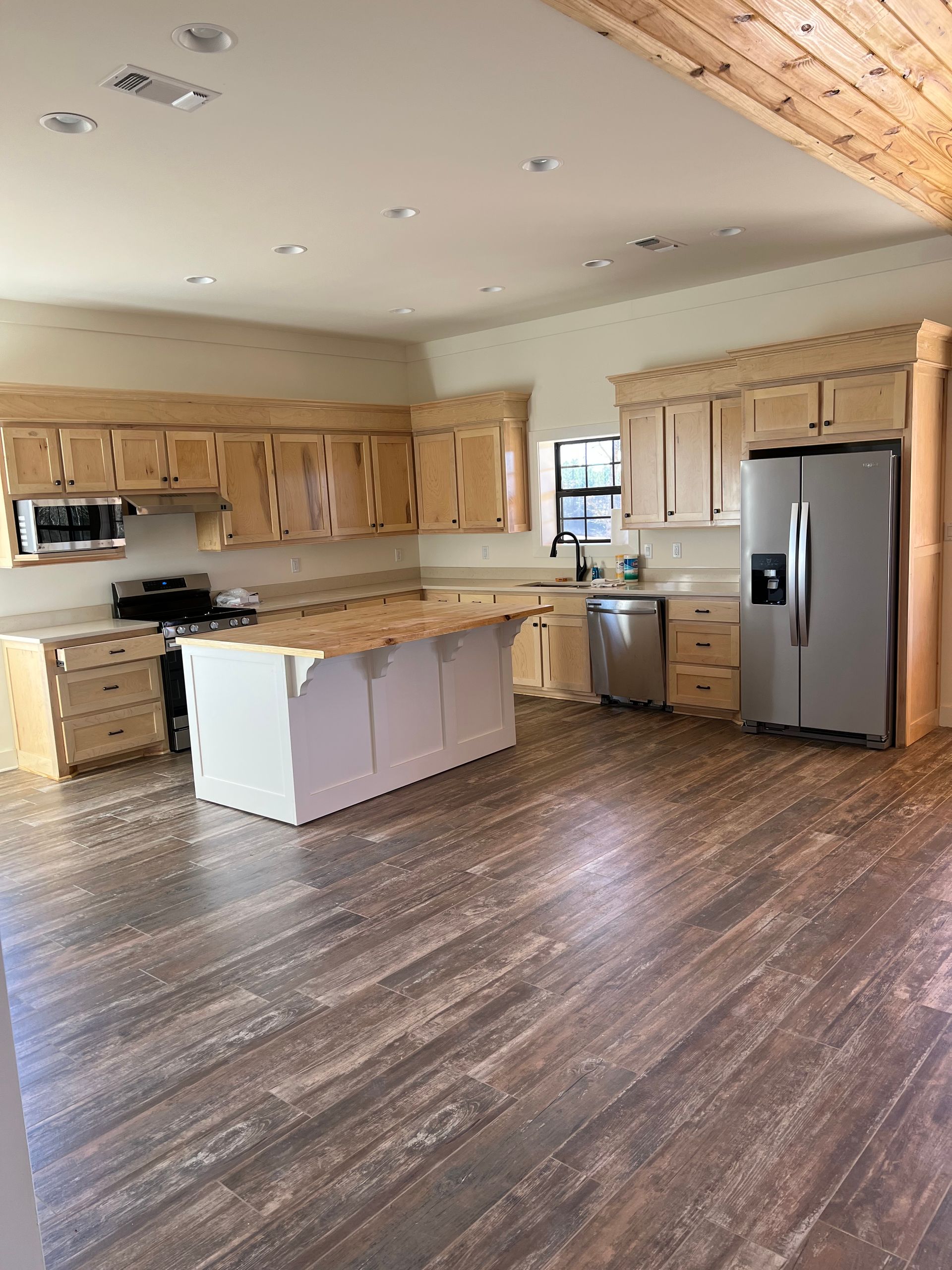 dark wooden floors with stained cabinets