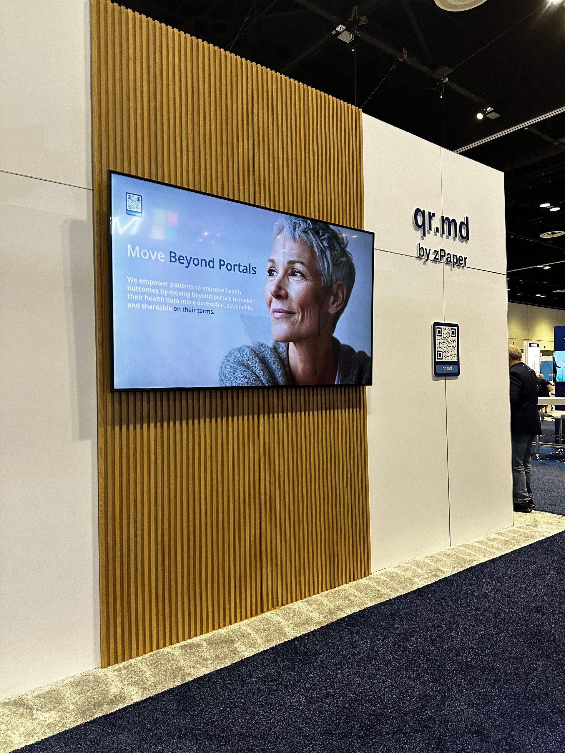 qr.md trade show booth with video wall