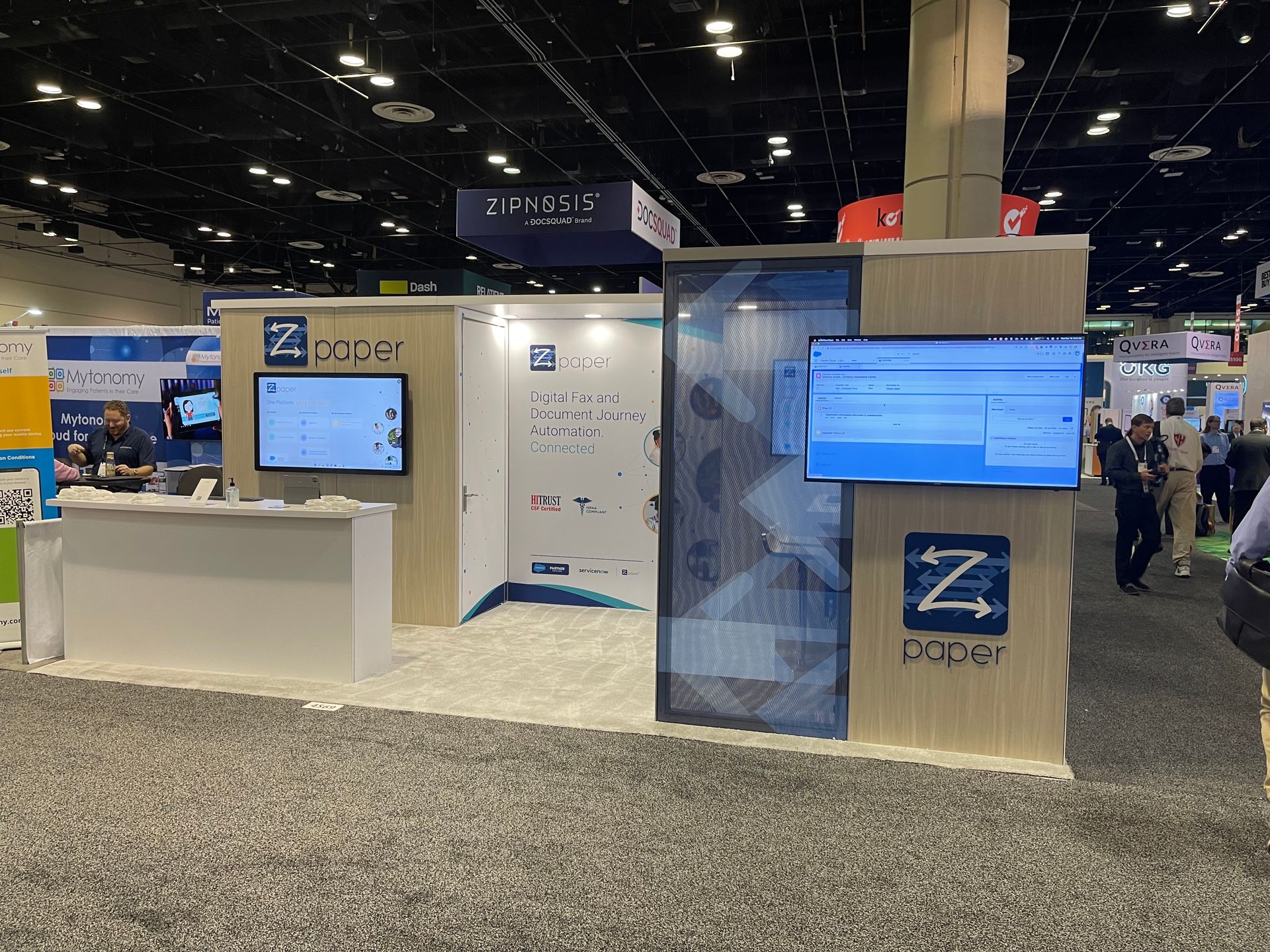 zPaper trade show booth with branded display wall