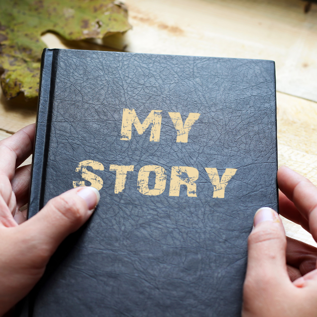 Man holding book titled 'My story' 

