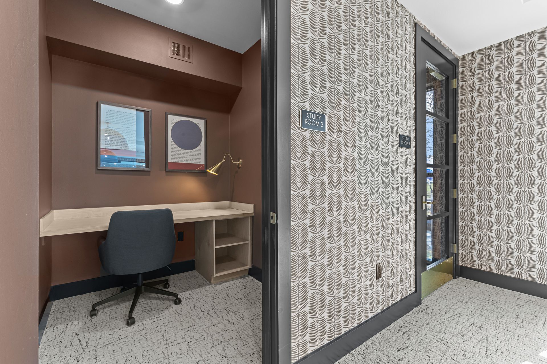 A room with a desk and chair in it.