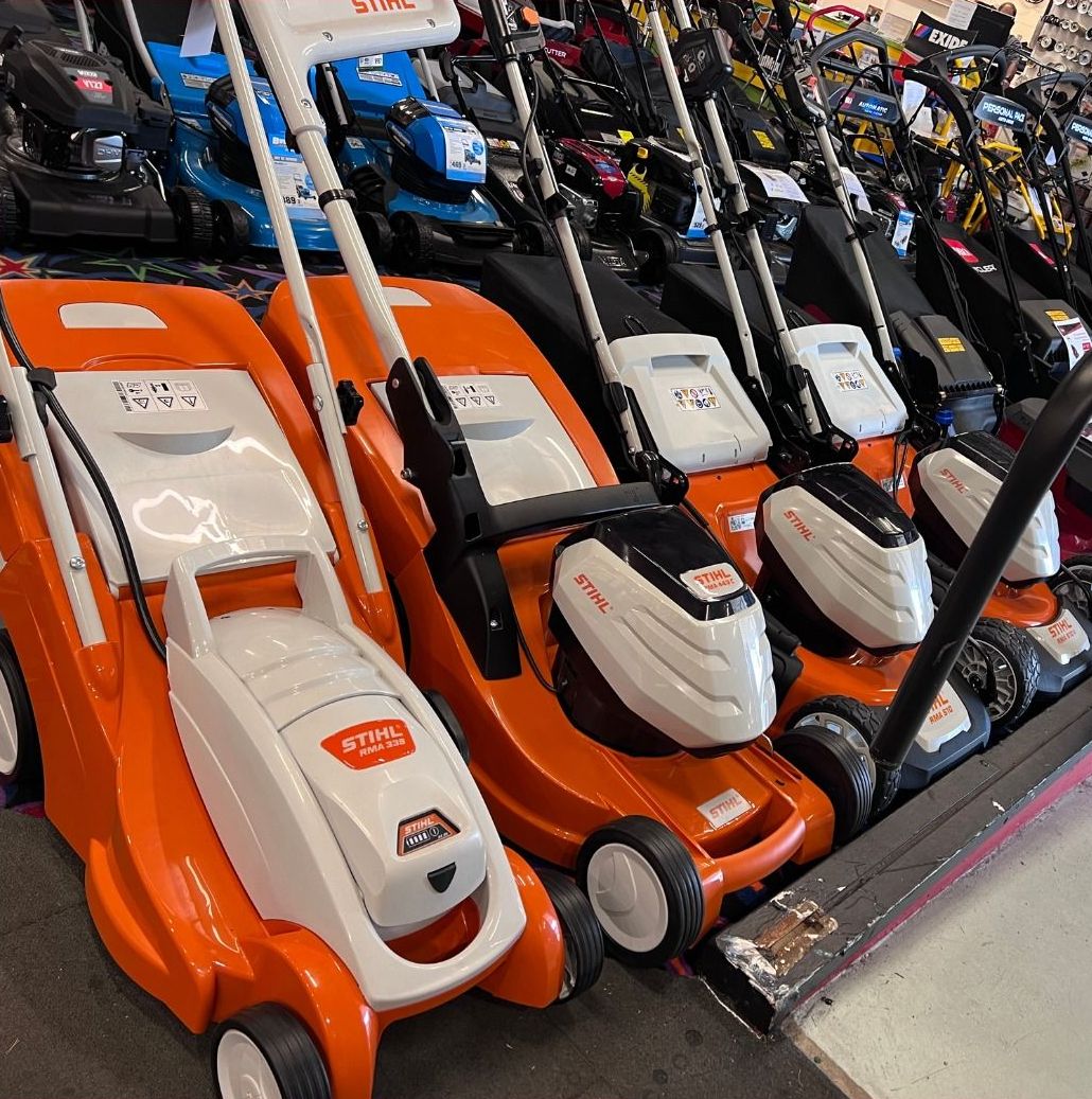 Row Of Orange And White Lawnmowers With Black Accents On Display In A Store — Whitsunday Mowers In Proserpine, QLD