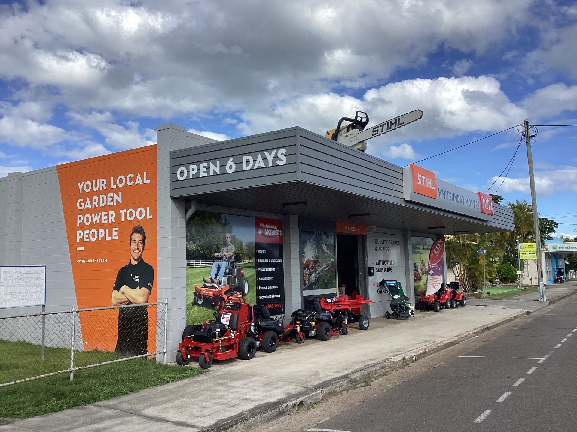 Two Cars Are Parked In Front Of A Store — Whitsunday Mowers In Proserpine, QLD