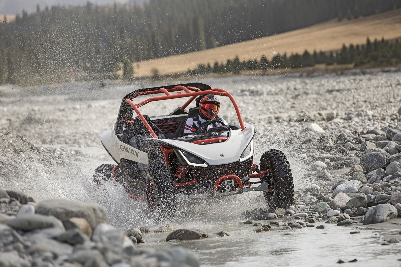 Side-By-Side Off-Road Vehicle Splashing Through Water in A Rocky Riverbed — Whitsunday Mowers In Proserpine, QLD