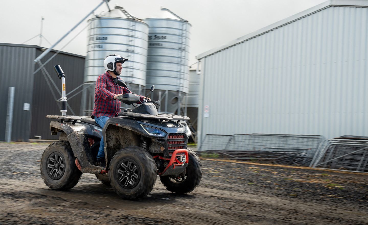 A Man Is Working On A Lawn Mower On A Wooden Pallet — Whitsunday Mowers In Proserpine, QLD