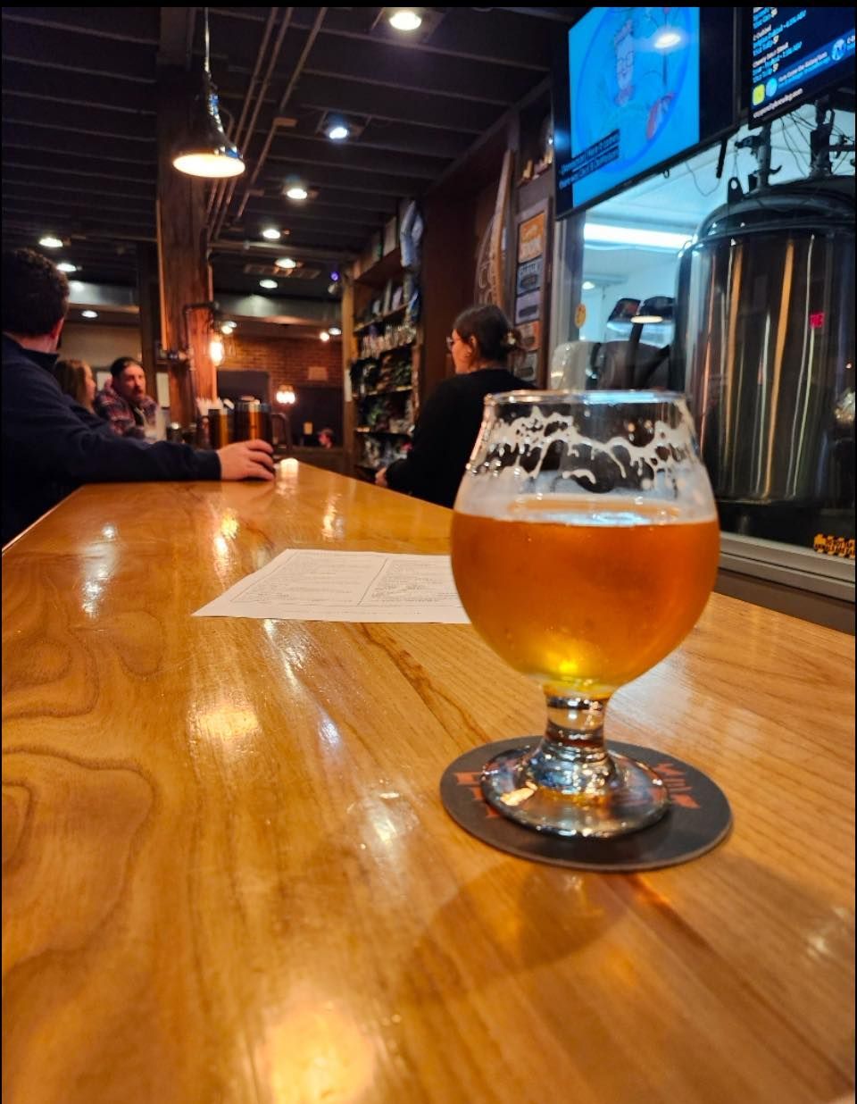 Beer glass on a wooden bar