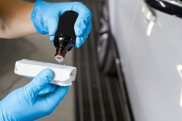 worker putting liquid in the cloth