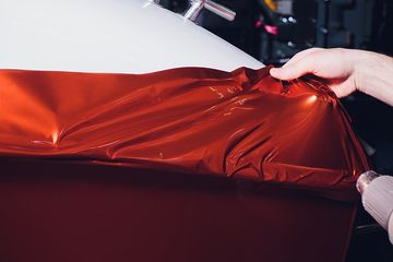 worker holding the car wraps