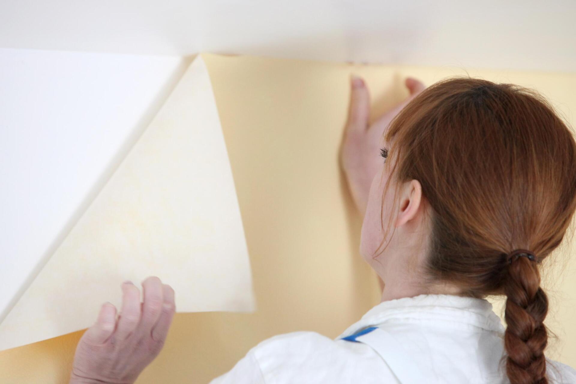 woman installing the vinyl wall wraps