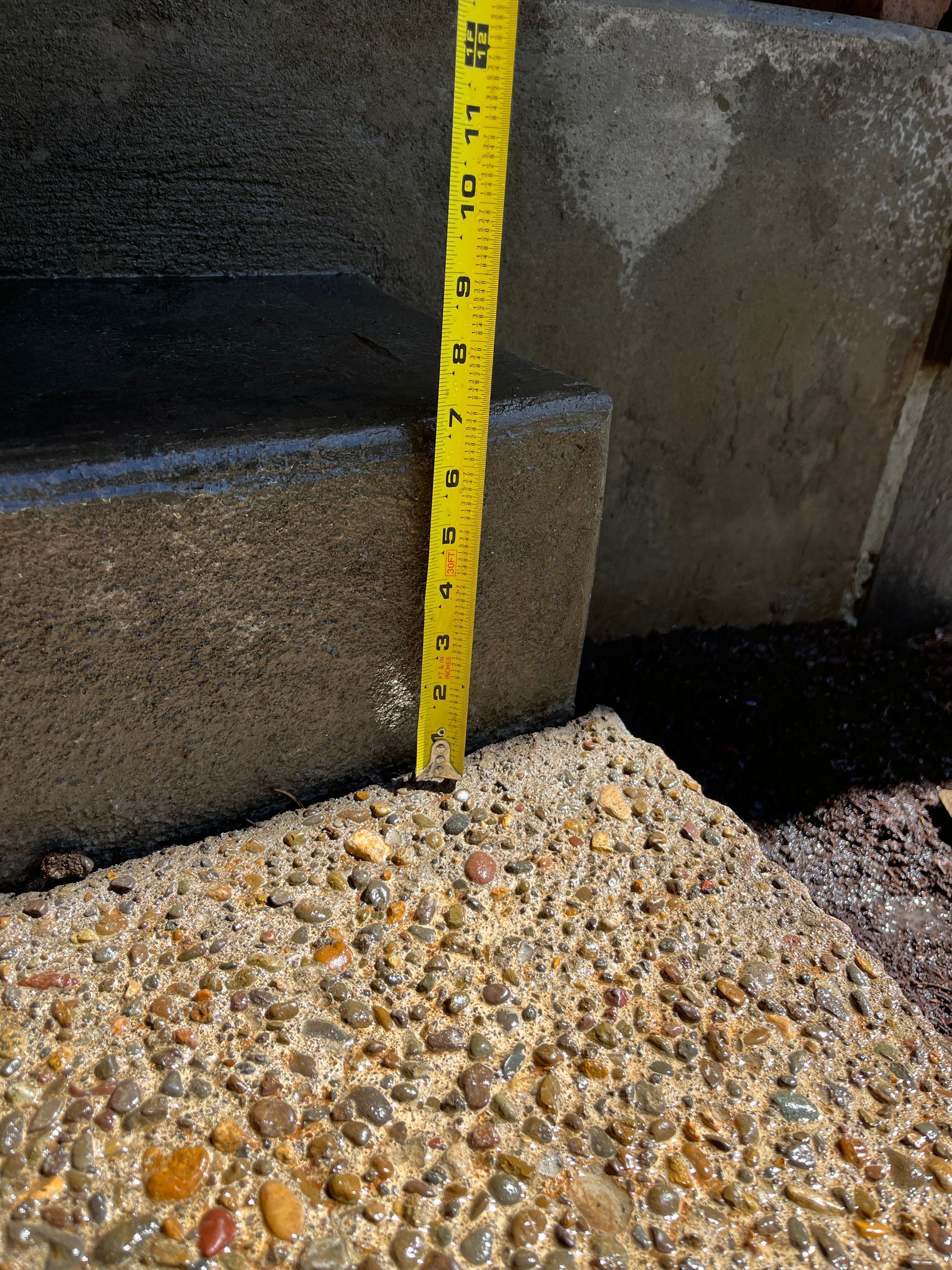 Measure Is Being Used To Measure A Concrete Surface