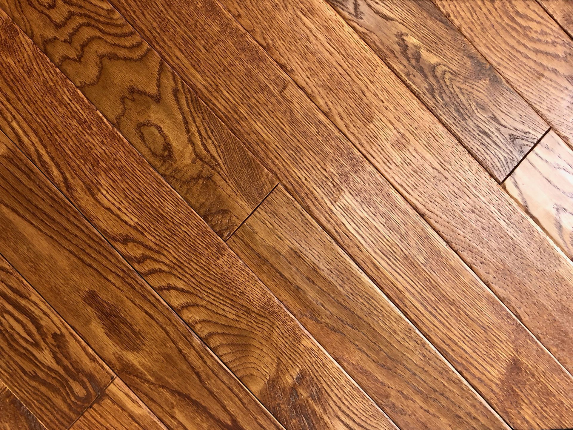 A close up of a wooden floor with a diagonal pattern.