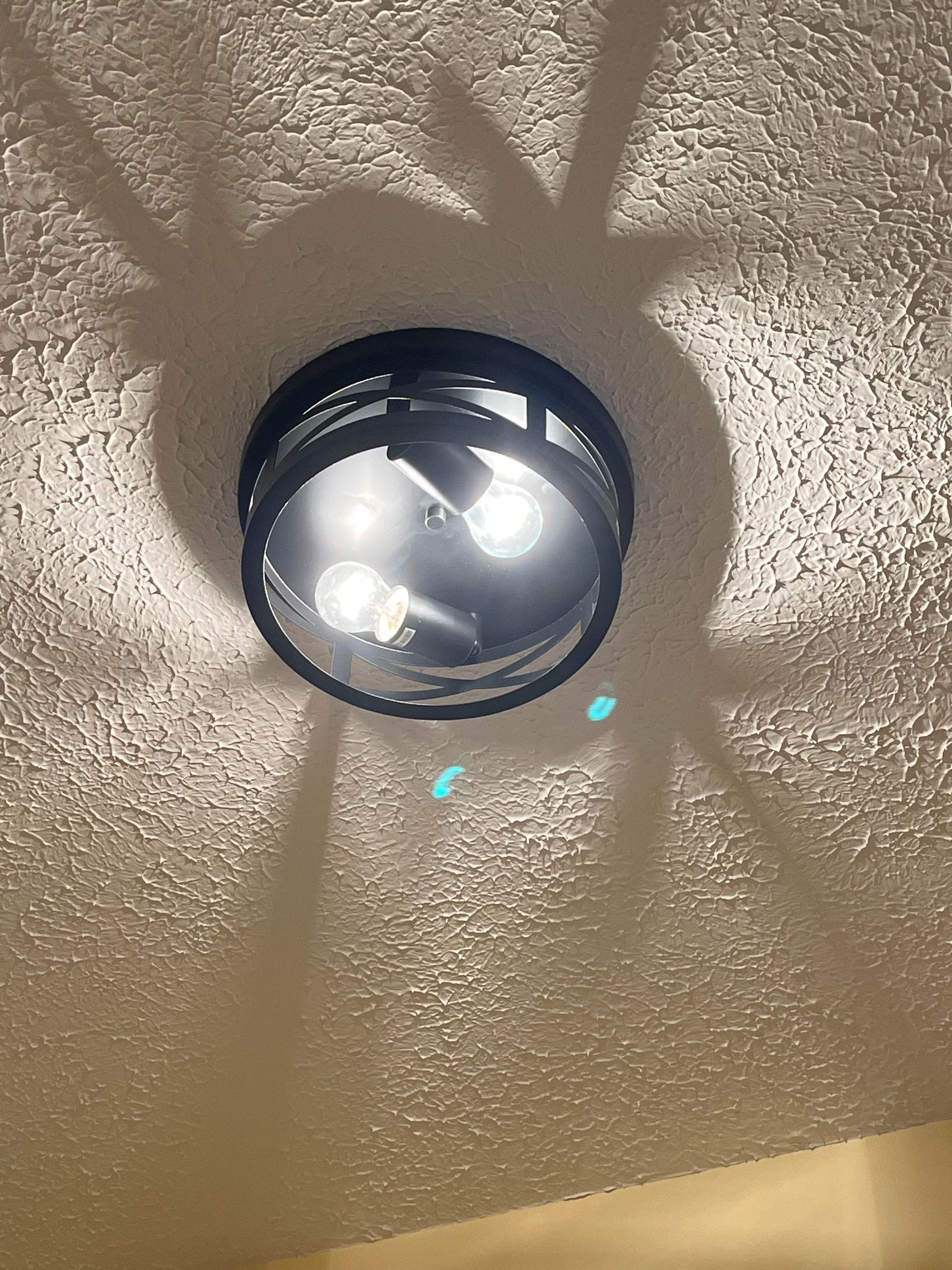 A bathroom with a mirror and lights on the ceiling.