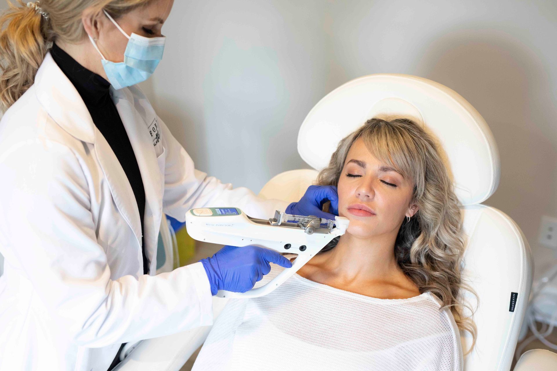 woman smiling at camera with under eye patches