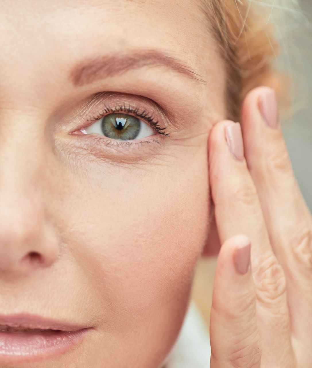 woman with perfect skin touching face