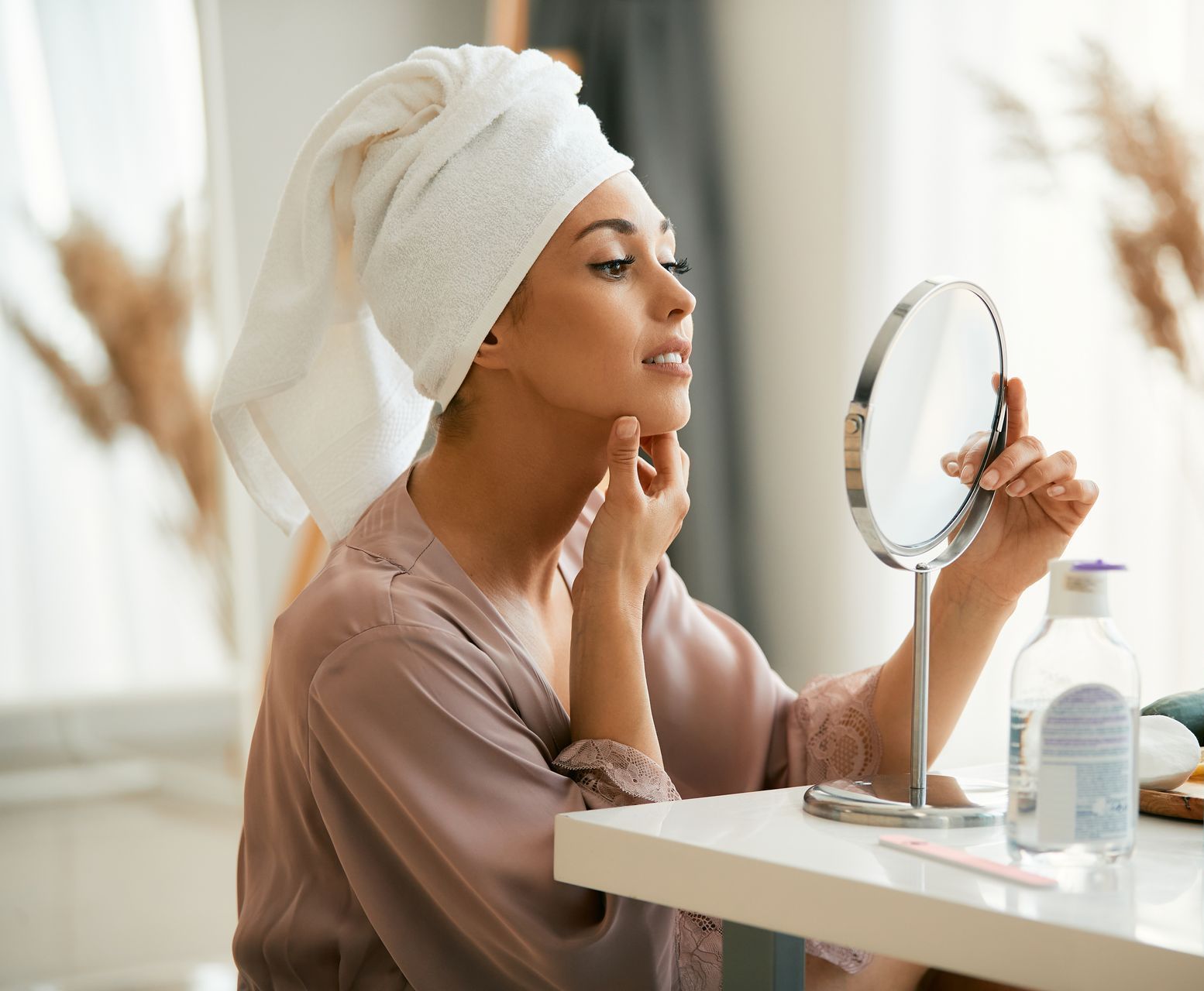 woman looking at chin in mirror