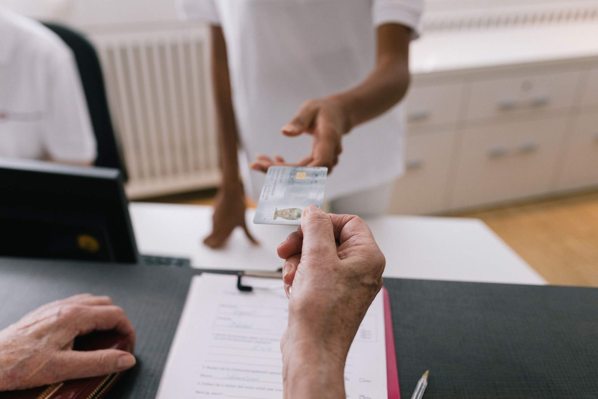 A person is handing a card