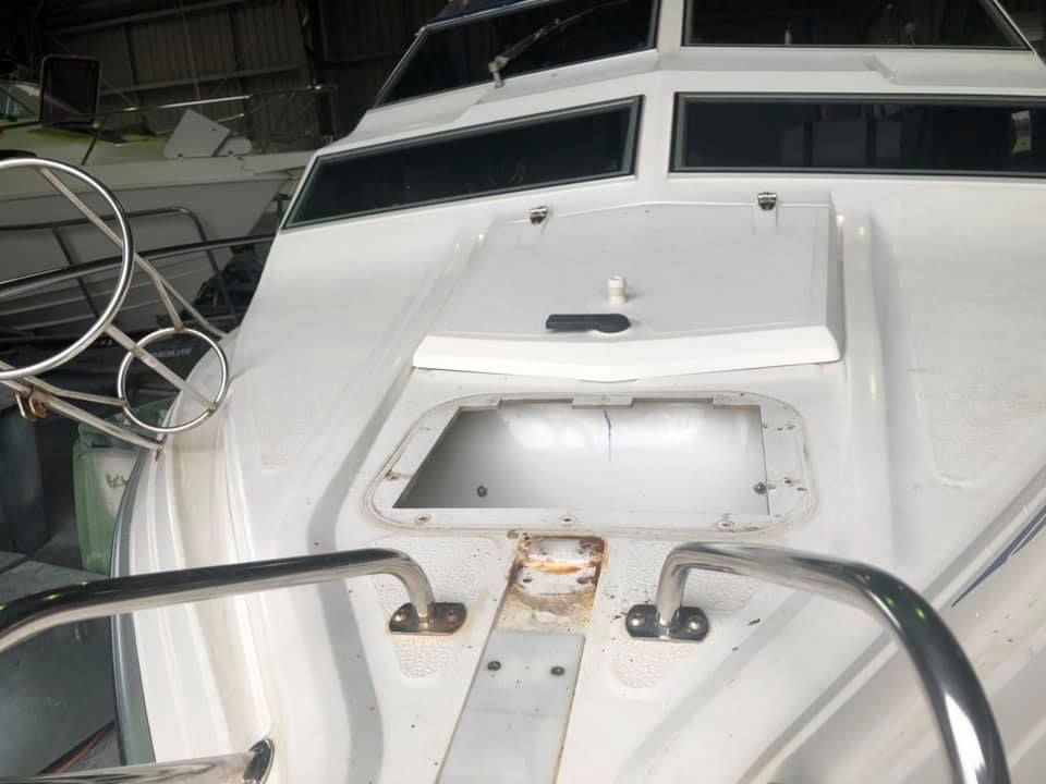 A White Boat With A Steering Wheel And A Stainless Steel Railing — Murraycraft Fibreglass In Glenella, QLD
