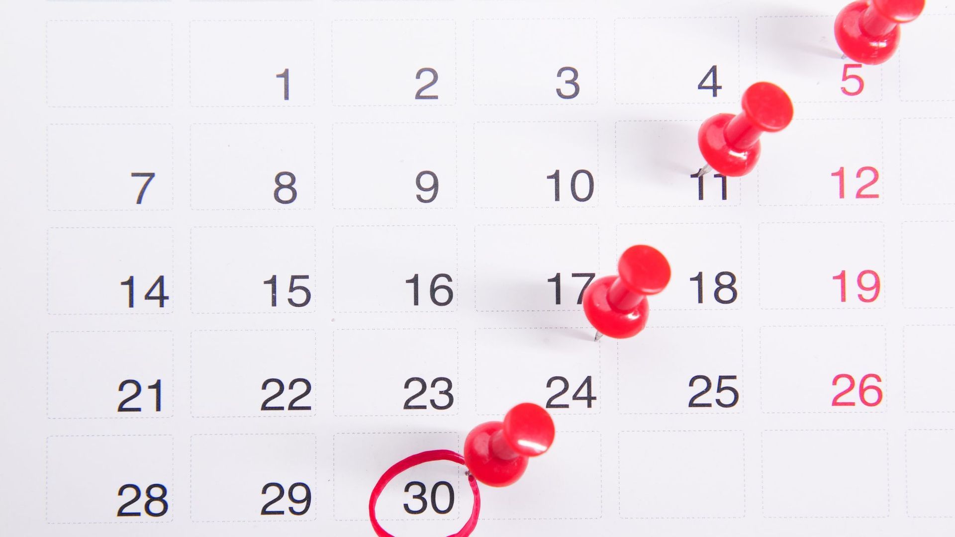 A calendar with pins marking several dates