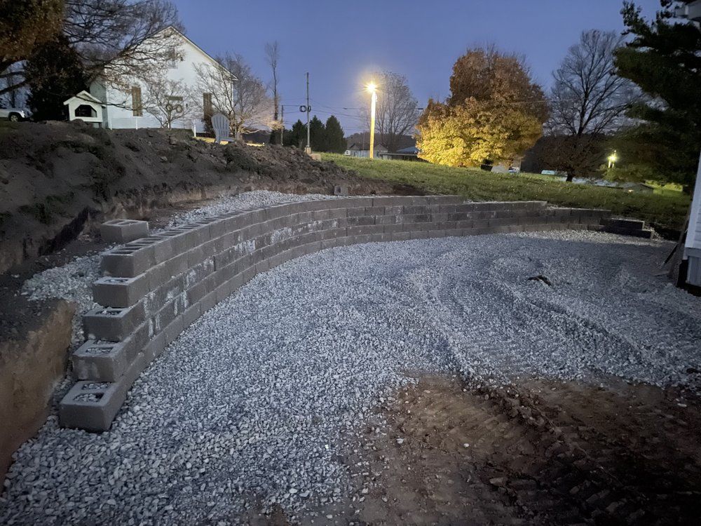A brick wall is being built on top of a pile of gravel.