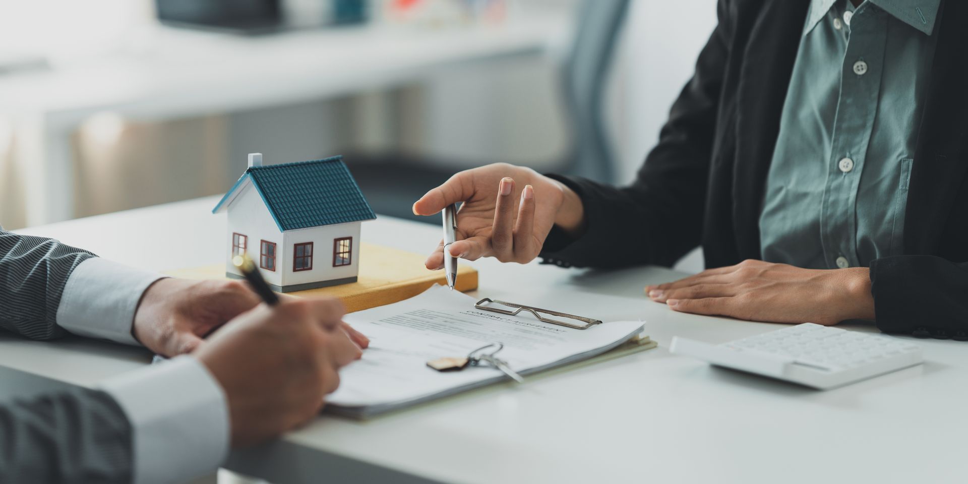 Real Estate agent explain signing agreement for buying house.