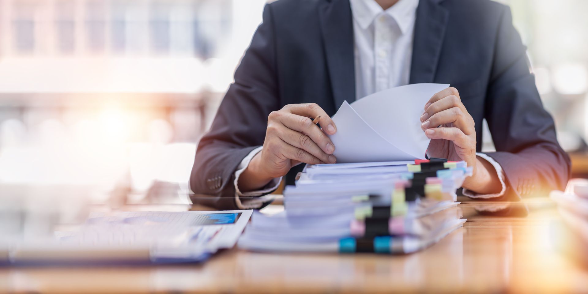 Attorney reviewing tabbed documents, representing support from a business law firm