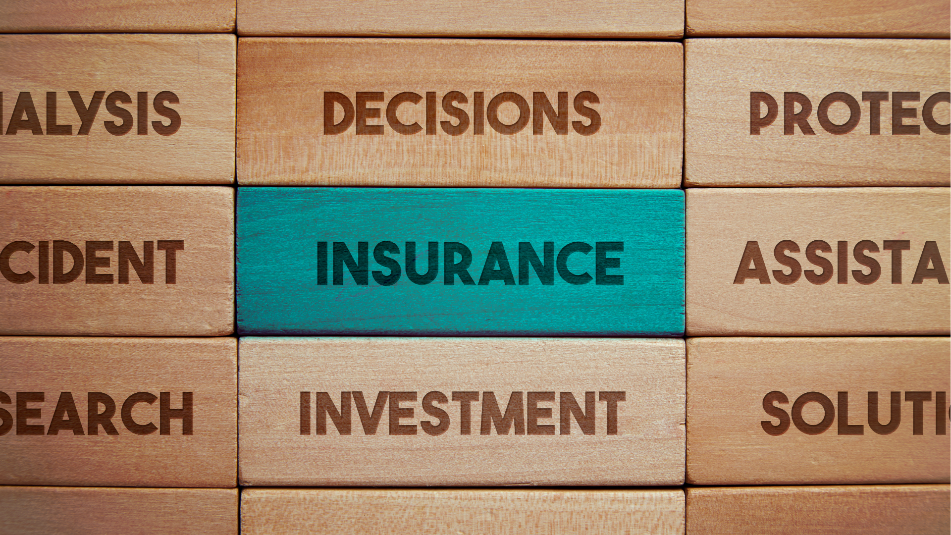 Wooden blocks labeled with business words; “INSURANCE” is highlighted in teal.