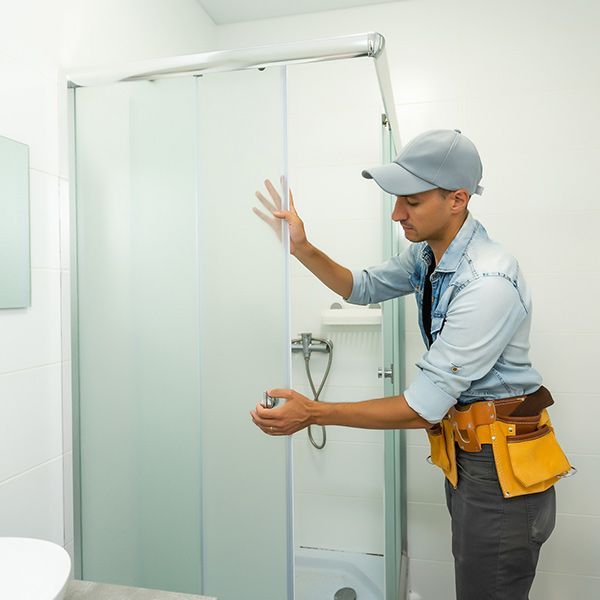 man installing new shower door