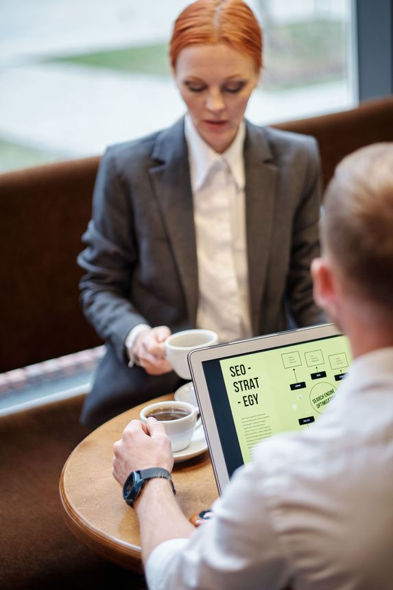 Overhead view of hands reviewing an analytics dashboard on a laptop
