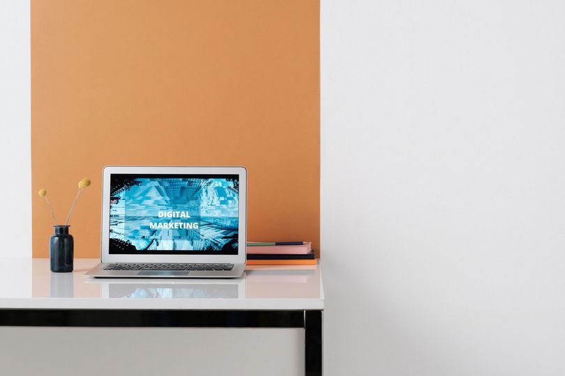A modern responsive website displayed on a laptop on a clean office desk
