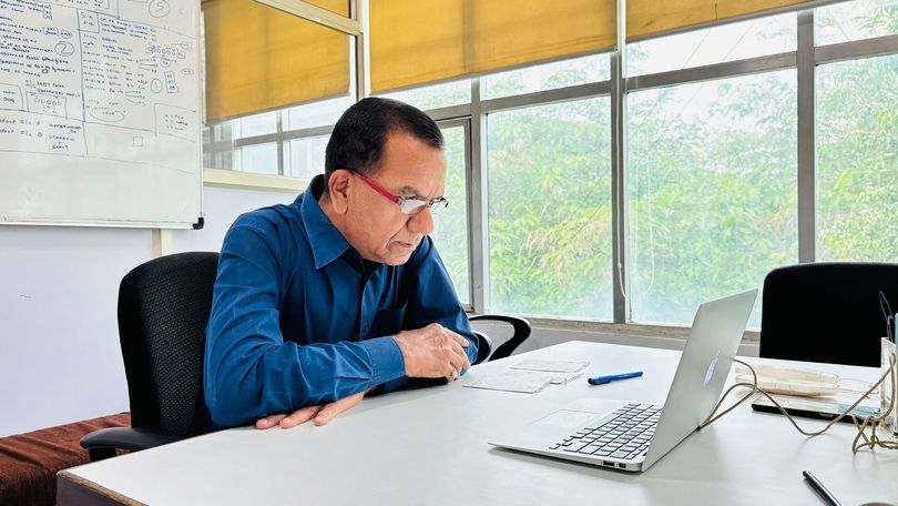 Clean professional workspace with an open laptop displaying a digital dashboard on a well-lit desk.