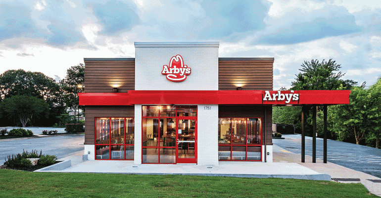 The front of an arby 's restaurant with a red awning.