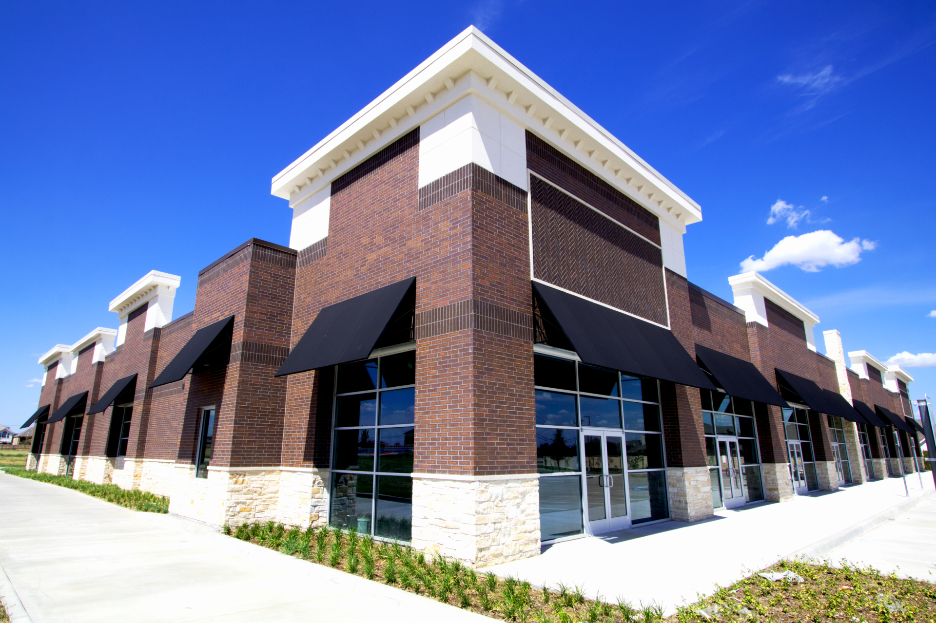 A large brick building with black awnings on the windows