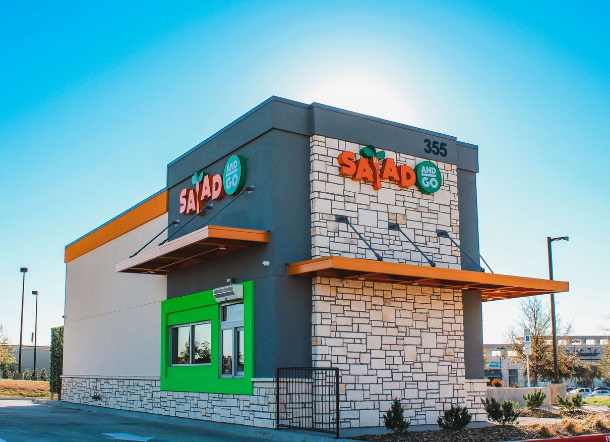 A fast food restaurant with a sign that says salad on it.