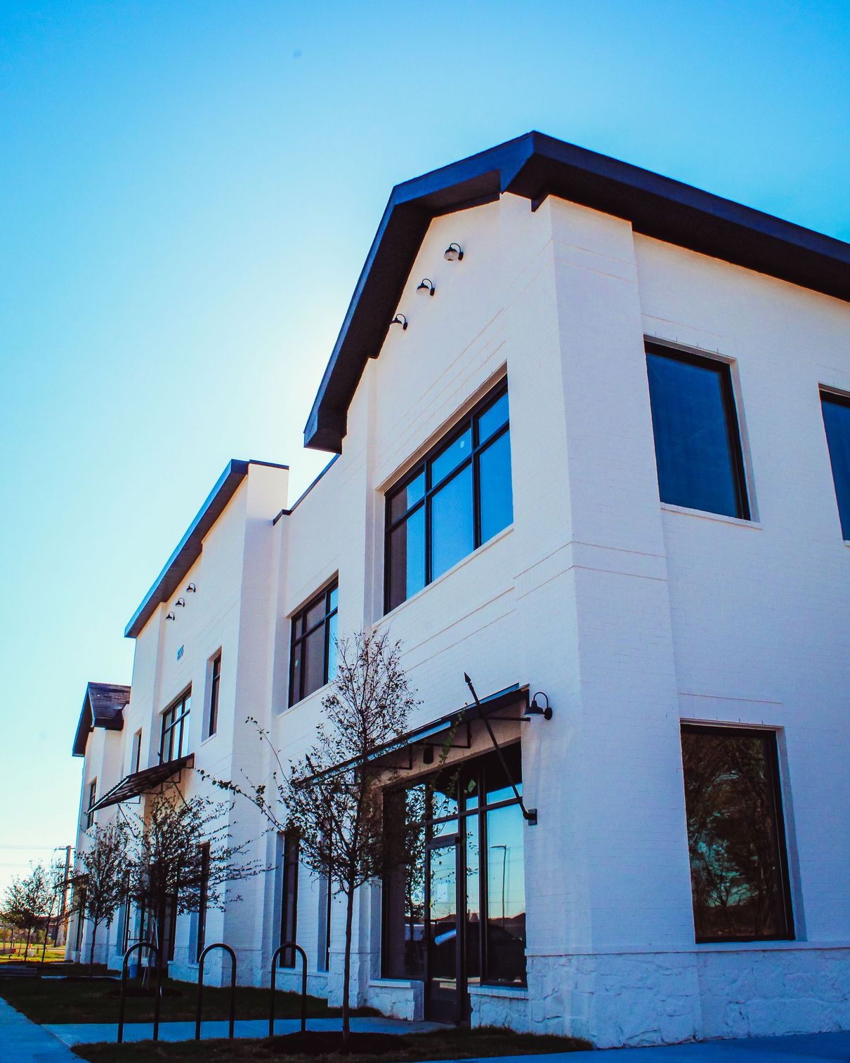 A large white building with a blue sky in the background