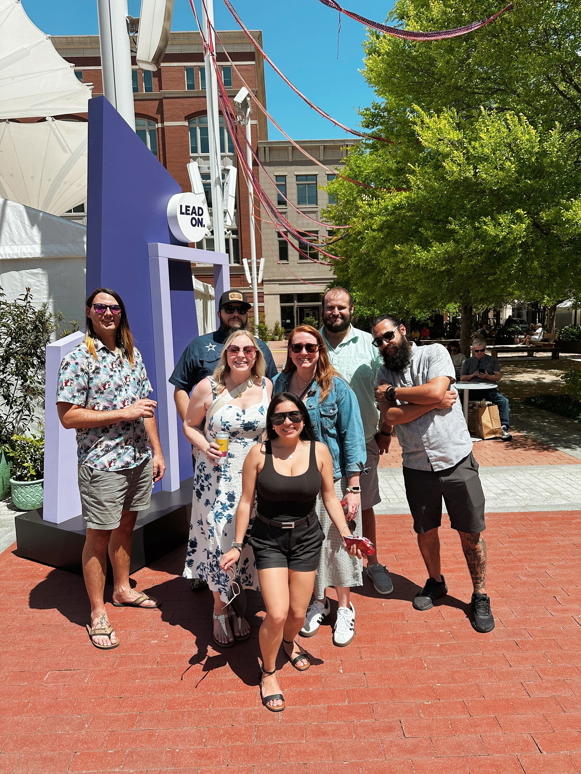 A group of people are posing for a picture in front of a building.