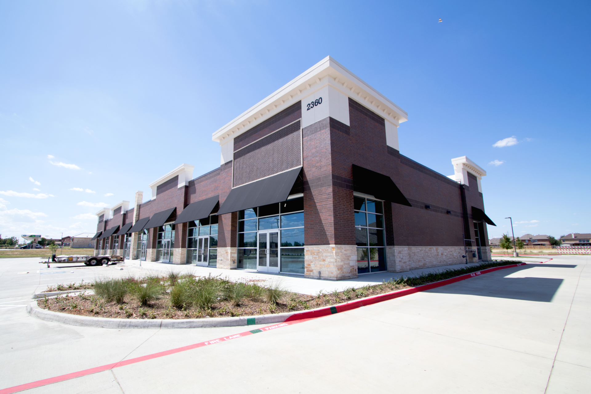 A large brick building with a lot of windows and awnings.