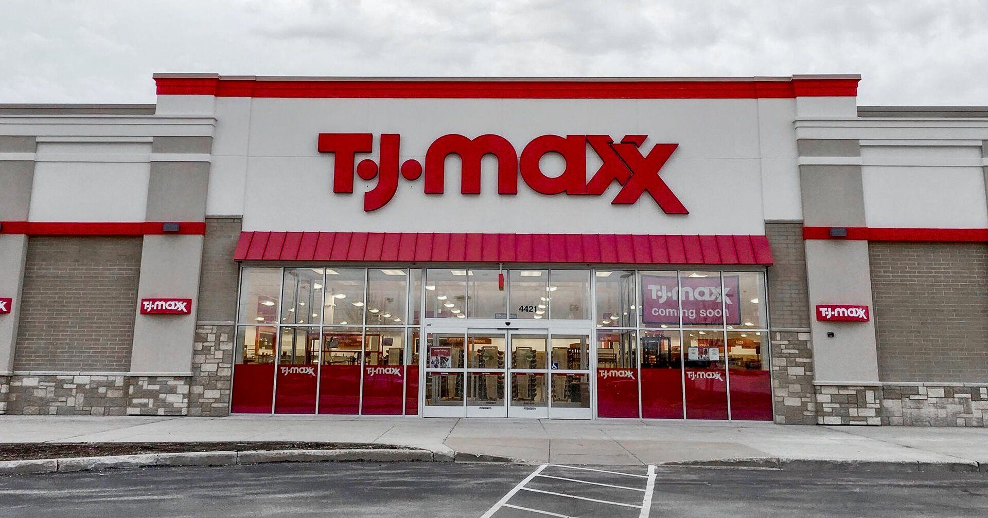 The front of a tj maxx store with a red awning