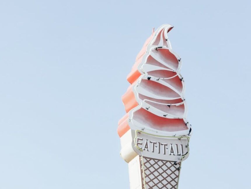 A large, faded ice cream cone sign with the words 