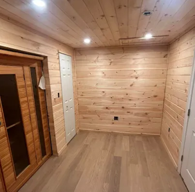 Spacious finished basement with a pool table, black leather seating, and large windows. Spacious finished basement with a pool table, black leather seating, and large windows.