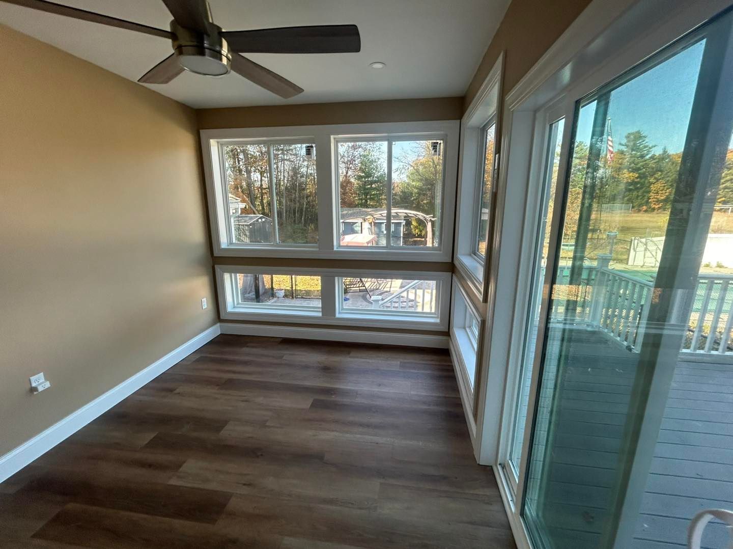 Interior with hardwood floors, three room openings, and dining table. Beige walls with natural light. Interior with hardwood floors, three room openings, and dining table. Beige walls with natural light.